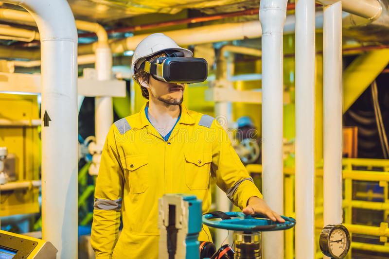 Man in yellow overall standing in oil and gas augmented reality glasses