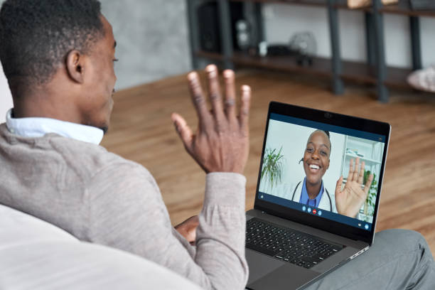 Male patient talking on conference video call to a doctor. Virtual therapist consulting young man during online appointment on laptop at home. Telemedicine chat, telehealth meeting